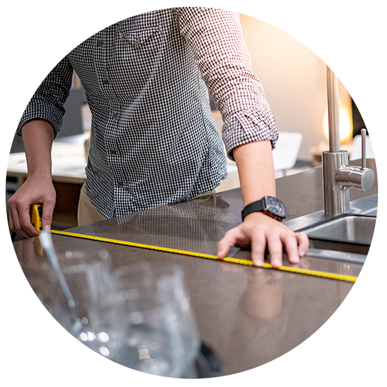 Man measuring kitchen countertops