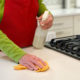 Homeowner sanitizing her kitchen countertops