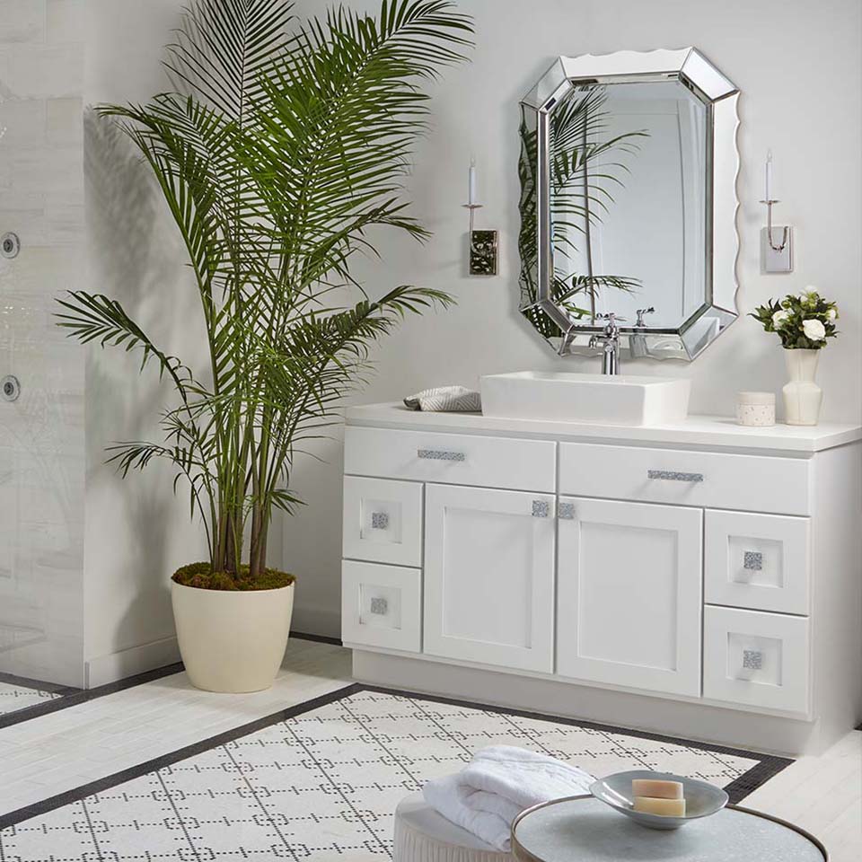 White bathroom with white vanity and raised bowl sink.