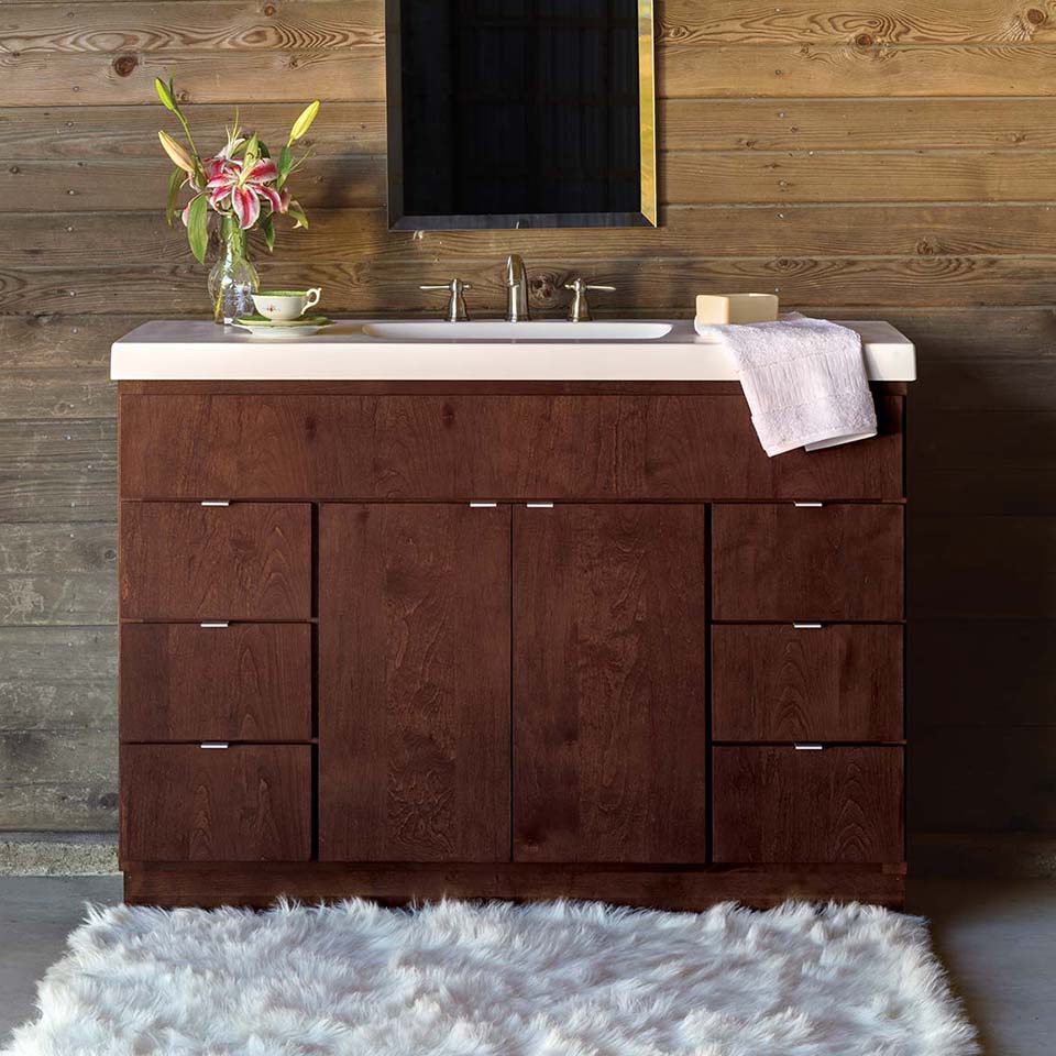 Dark wood modern bathroom vanity with light top.