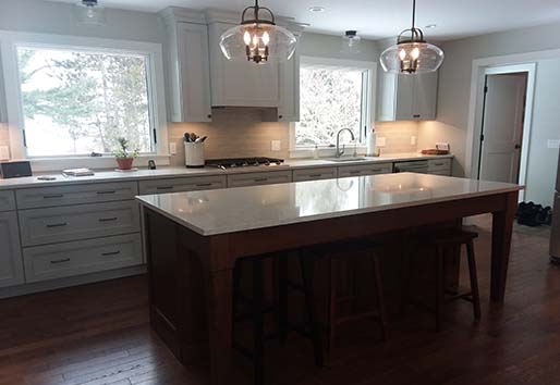 White kitchen cabinets and large kitchen island with seating