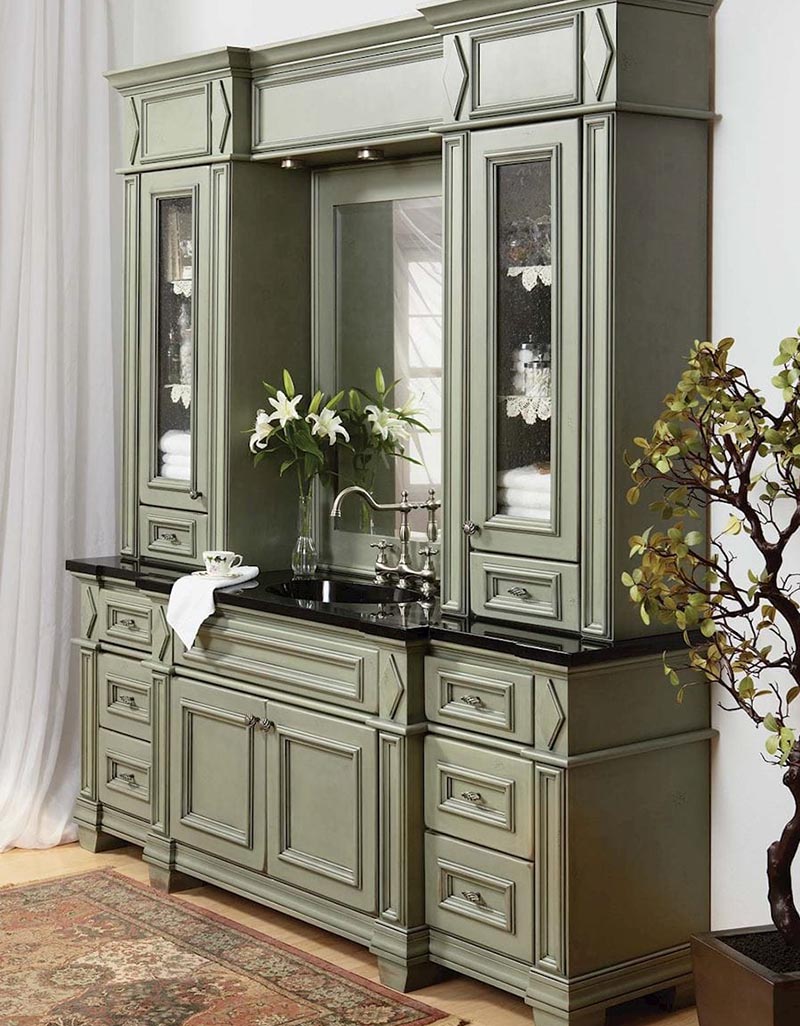 Custom designed green bathroom vanity and surrounding cabinets