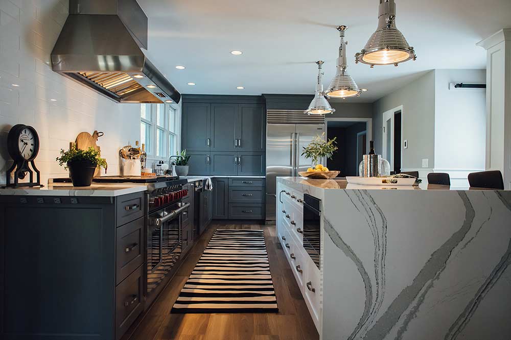 large kitchen with dark steel blue Mouse cabinets and white Mouser island cabinets, stainless appliances