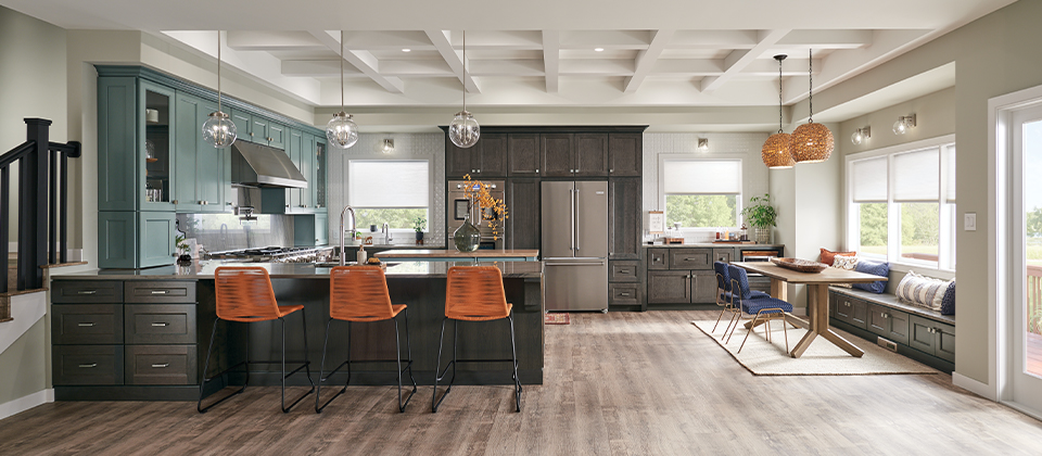 The Top Kitchen Cabinet Trends of 2021, mixed walnut uppers and lowers and island, with some light teal uppers, mixed glass front