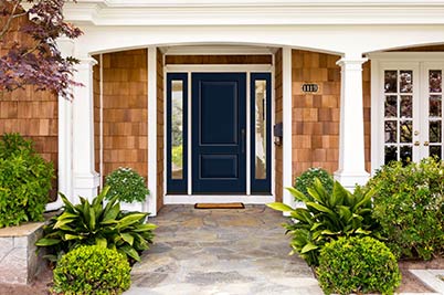 Home exterior with blue solid Thermatru door