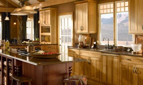 Large warm kitchen with honey oak cabinets and walnut island