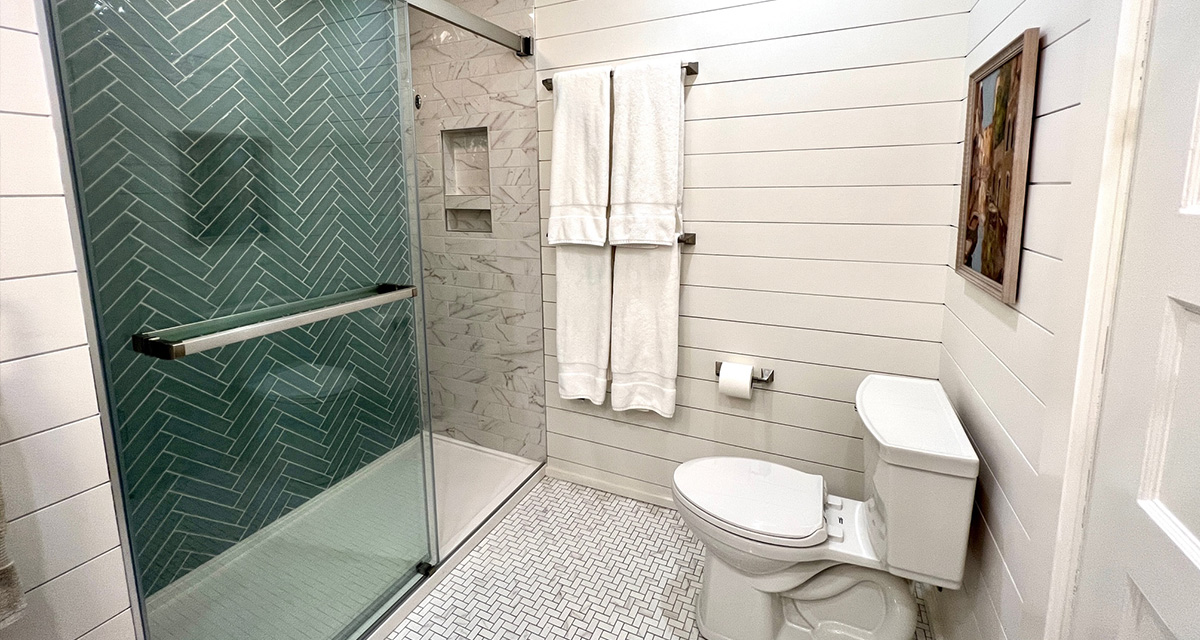 after Von Tobel remodel shiplap bathroom with glass & tile shower