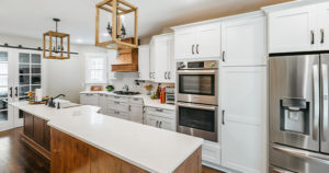 after Von Tobel remodel white and wood kitchen, black hardware & fixtures, wood flooring