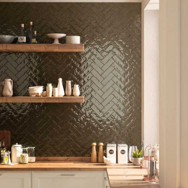 Textured tile backsplash in herringbone pattern